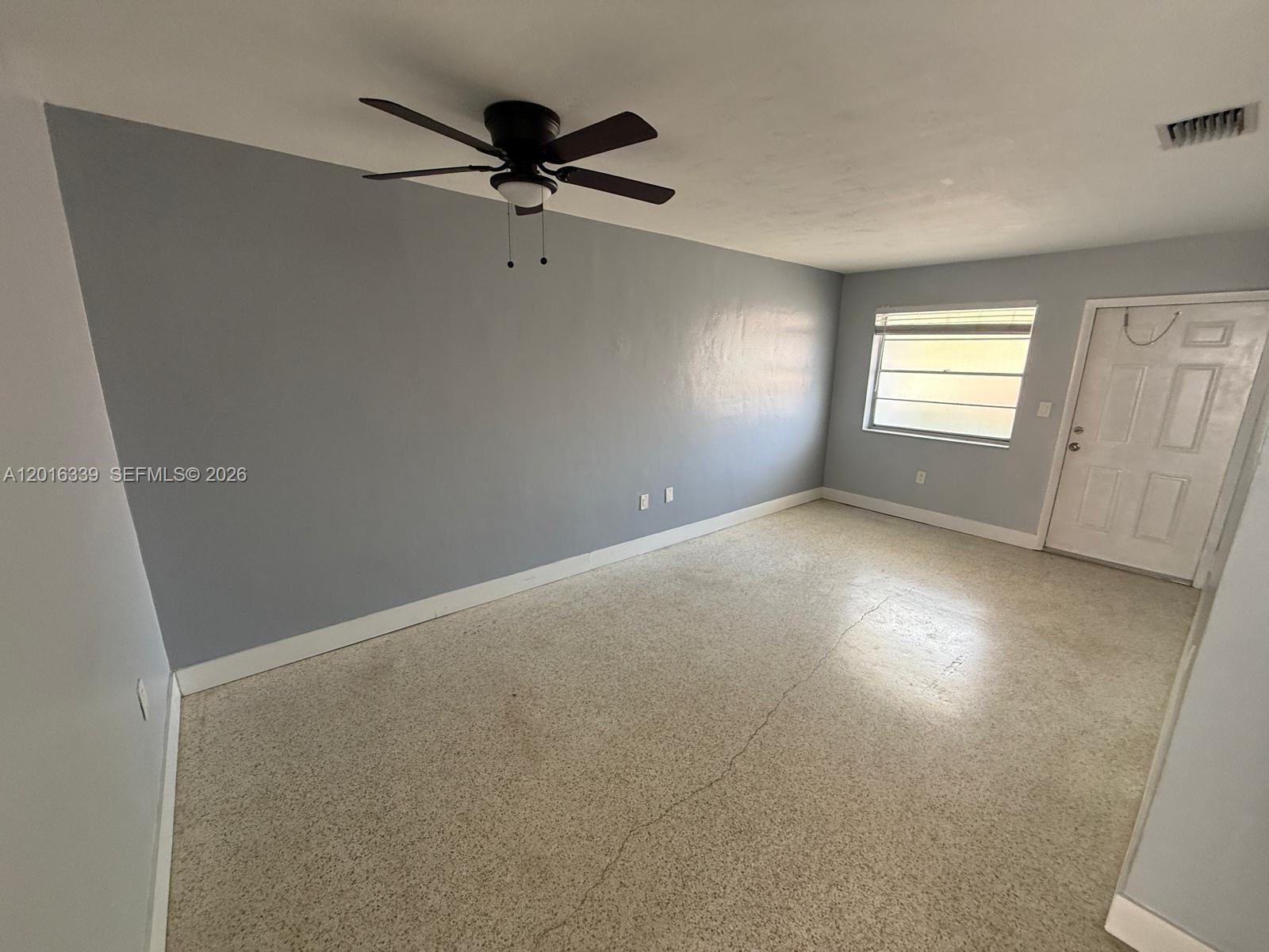 990 Southwest 4th Street, Unit 6 Miami, FL 33130 - Photo 4 of 6 a view of a room with a window and a ceiling fan