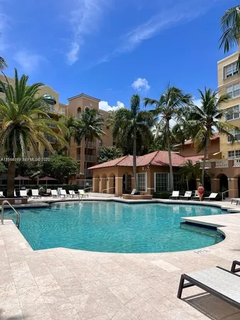 a view of a house with a swimming pool and sitting area