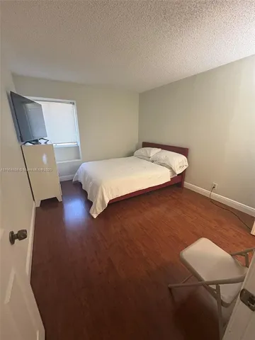 a bedroom with a bed and chair