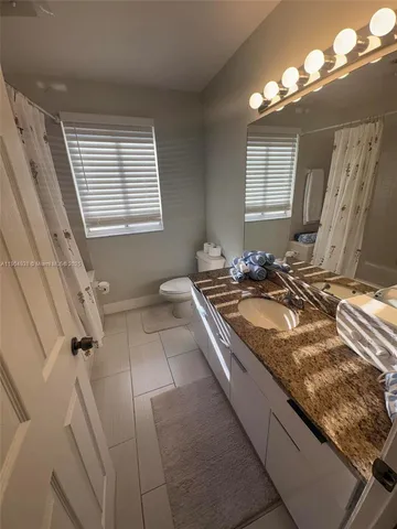 a bath room with a sink and a mirror