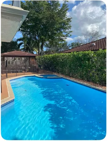 a view of a swimming pool with an outdoor space and seating area