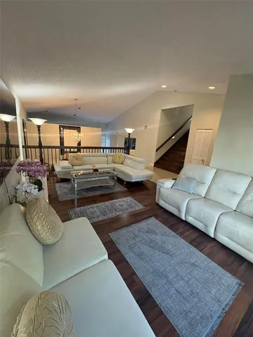 a living room with furniture and a rug