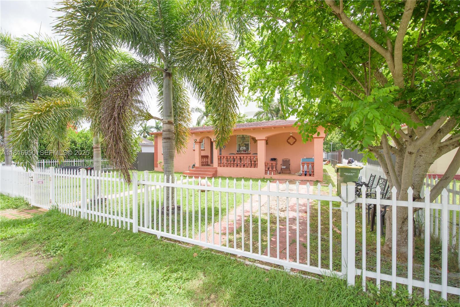 916 Northwest 3rd Avenue Homestead, FL 33030 - Photo 2 of 35 a view of a house with a small yard and a large tree