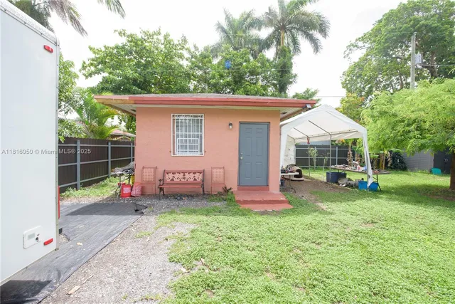 a view of a house with backyard and sitting area