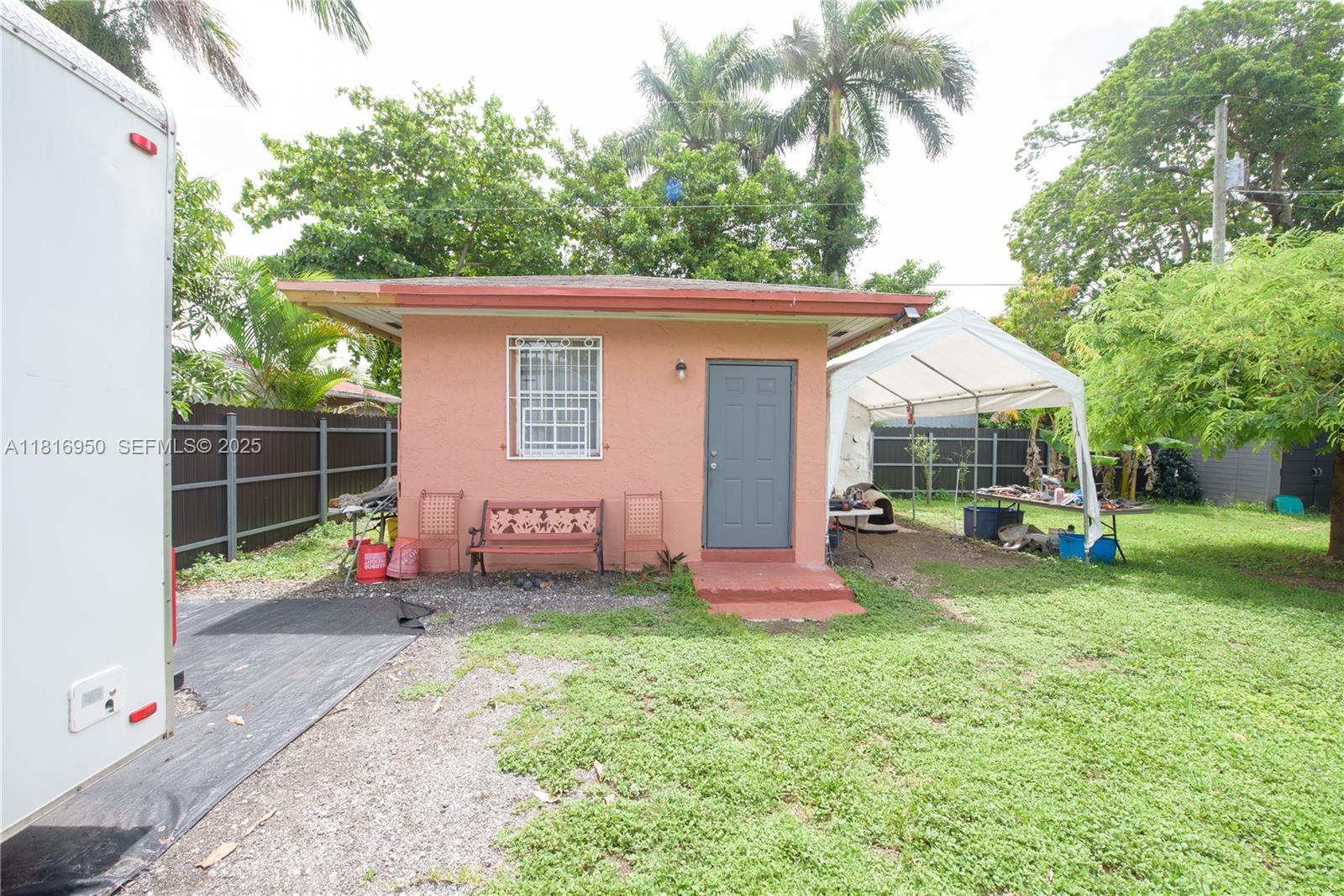 916 Northwest 3rd Avenue Homestead, FL 33030 - Photo 21 of 35 a front view of a house with a yard table and chairs