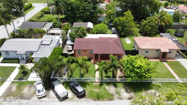 an aerial view of a house with a yard and lake view