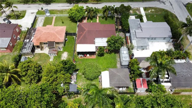 an aerial view of a house with a yard and lake view