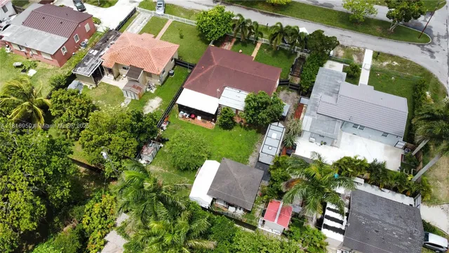 an aerial view of a house with garden space and street view