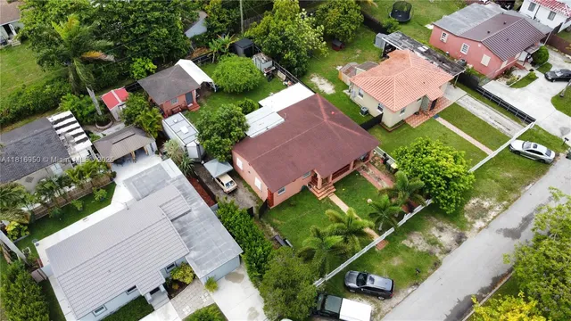 an aerial view of a house with a yard basket ball court and outdoor seating