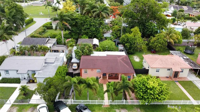 an aerial view of a house with garden space and street view