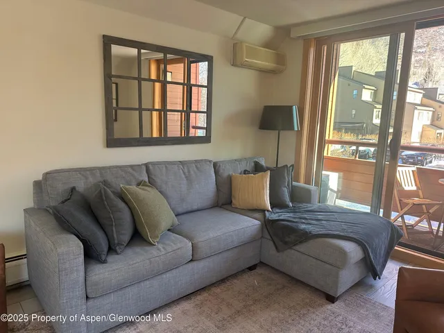 a living room with a couch and a large window
