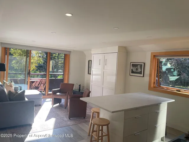 a living room with furniture a large window