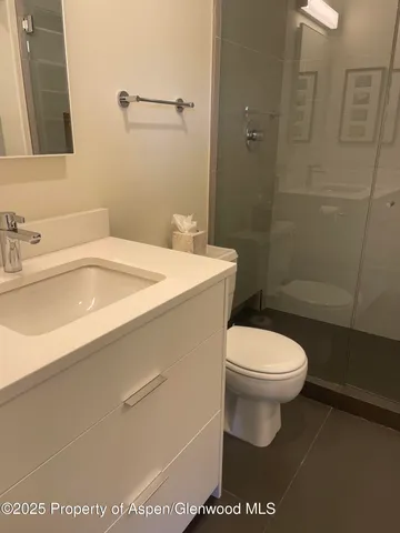 a white toilet sitting next to a bathroom sink