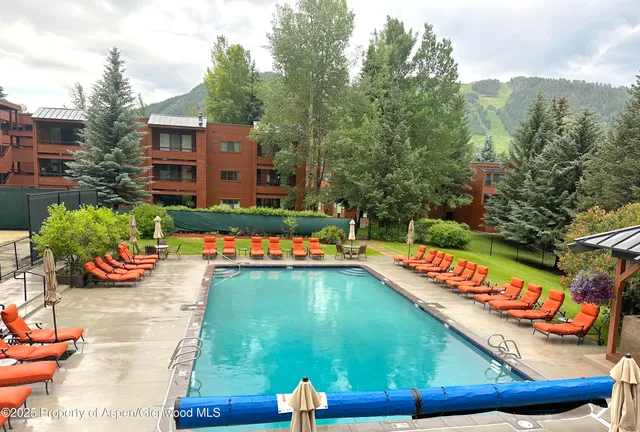 a view of a backyard with sitting area