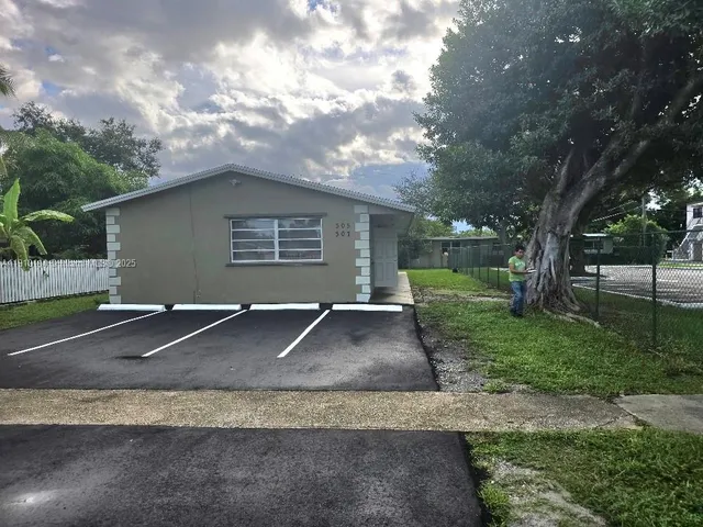 a view of a room with wooden floor and cabinet