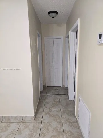 a kitchen with a stove top oven and cabinets