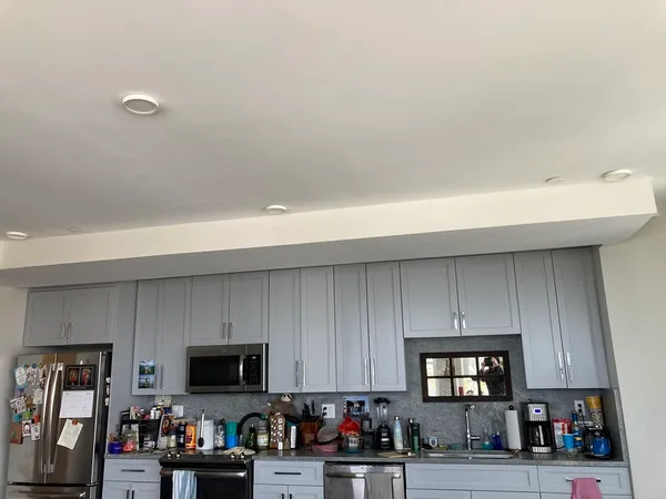 a kitchen with a sink cabinets and stainless steel appliances