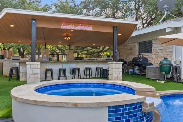 a view of swimming pool with lawn chairs and a lawn chairs