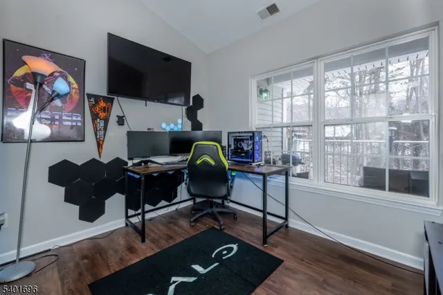 a view of a workspace with furniture and a window