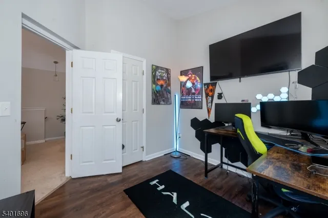 a work room with furniture and a flat screen tv