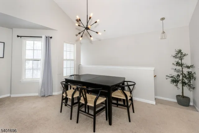 a view of a dining room with furniture and window