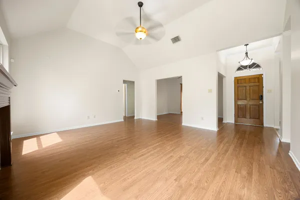 wooden floor in an empty room with a window
