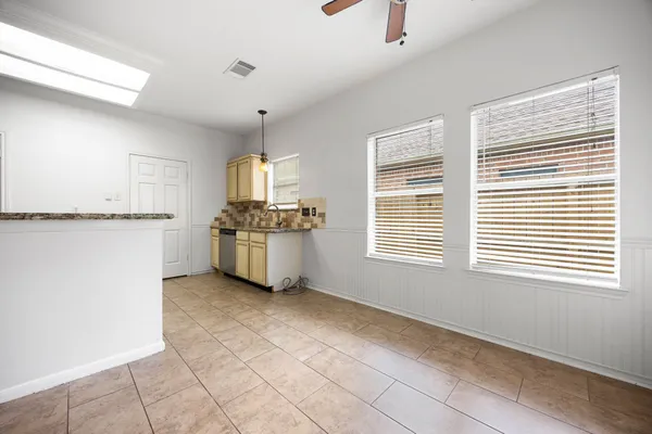 a kitchen with granite countertop white cabinets and white appliances