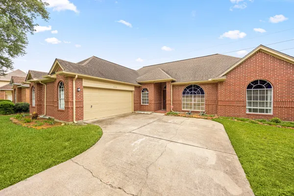 a view of a house with backyard and garage