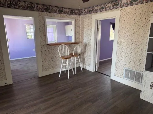 a view of a hallway with wooden floor and furniture