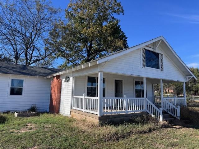 2032 Highway 338 Naples, TX 75568 - Photo 2 of 21 a view of a house with a yard and wooden fence