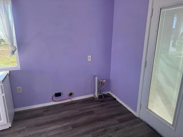 a view of a room with wooden floor and small window