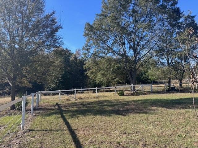 2032 Highway 338 Naples, TX 75568 - Photo 3 of 21 a backyard of a house with trees and outdoor seating