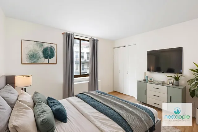 a bedroom with a bed and a flat screen tv