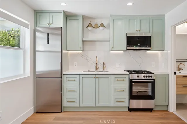 a kitchen with a stove and a refrigerator