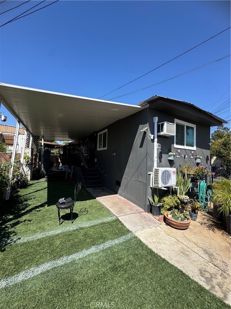 a view of a house with backyard porch and sitting area