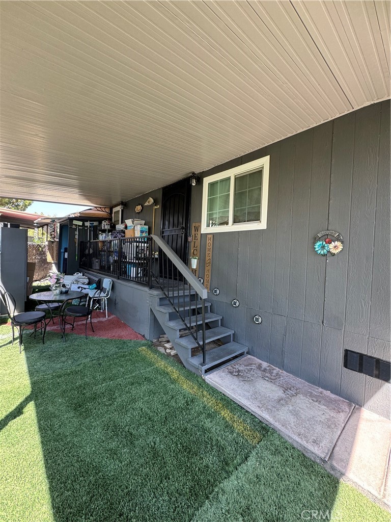 6045 Mission Boulevard, Unit 13 Riverside, CA 92509 - Photo 2 of 7 a view of a patio with table and chairs a barbeque with wooden fence
