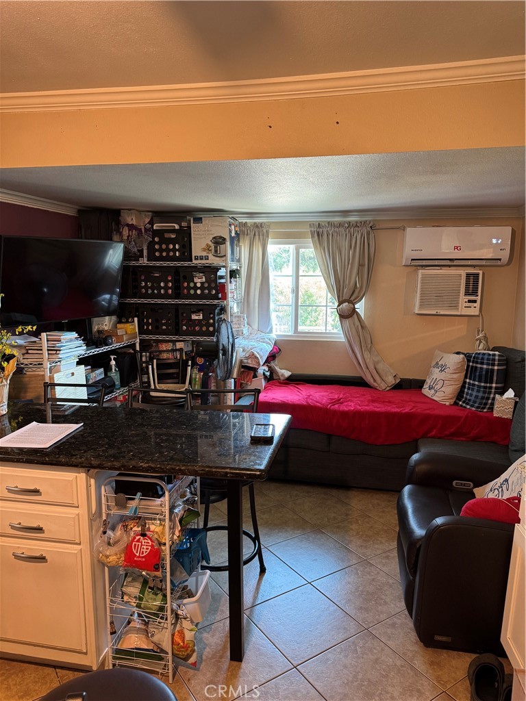 6045 Mission Boulevard, Unit 13 Riverside, CA 92509 - Photo 4 of 7 a room with furniture a air conditioner vent and a window