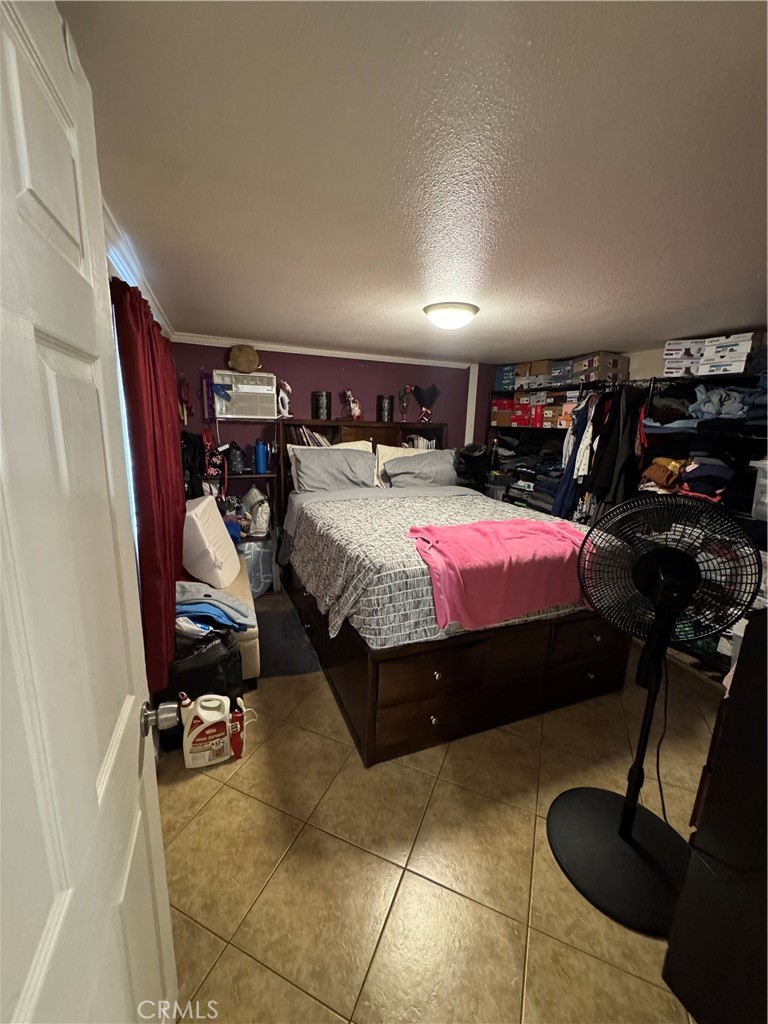 6045 Mission Boulevard, Unit 13 Riverside, CA 92509 - Photo 7 of 7 a bed room with a bed and a chair
