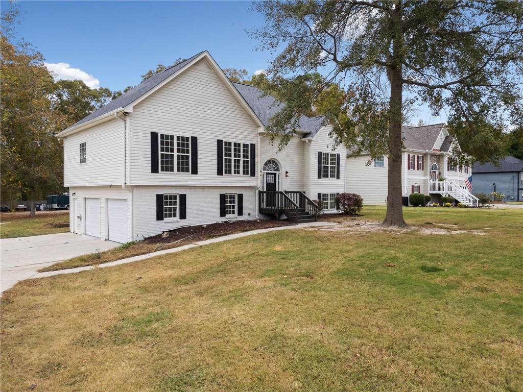 156 Brookside Way Villa Rica, GA 30180 - Photo 1 of 1 a view of a white house with a large tree next to a yard