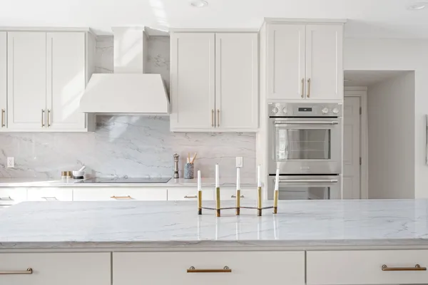 a kitchen with granite countertop a sink and cabinets