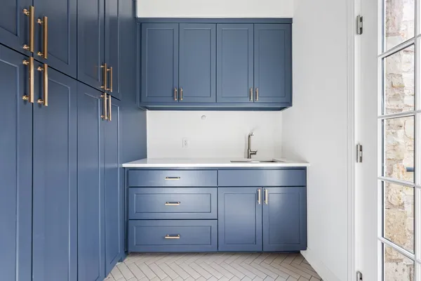 a room with a sink and cabinets