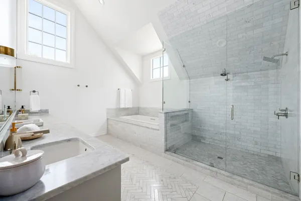 a bathroom with a granite countertop sink a toilet and shower