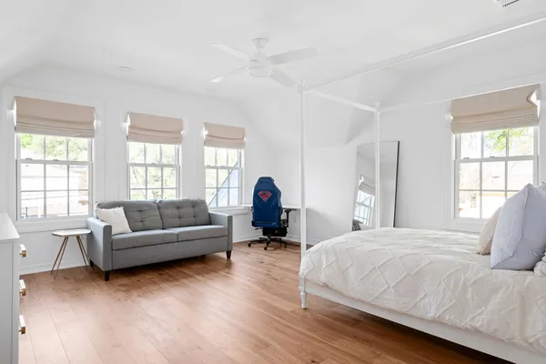 a living room with a bed furniture and a large window