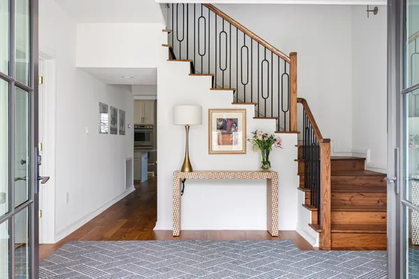 a view of entryway and hall with wooden floor
