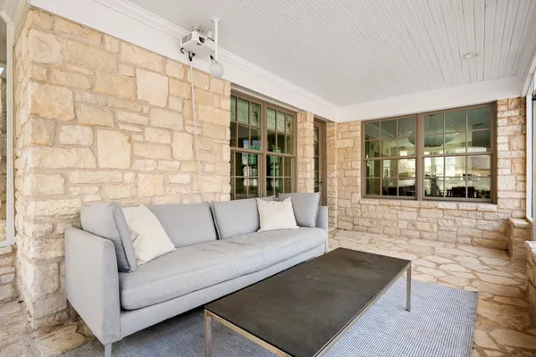 a living room with furniture and large window