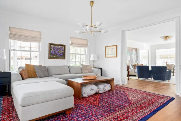 a living room with furniture rug and window