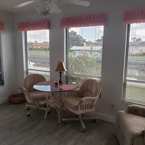 a view of a livingroom with furniture and a window
