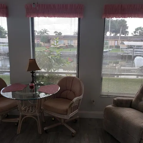 a living room with furniture and a floor to ceiling window