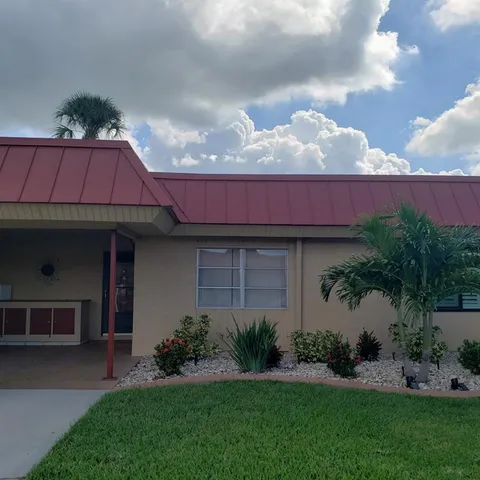a view of a house with a garden and pathway