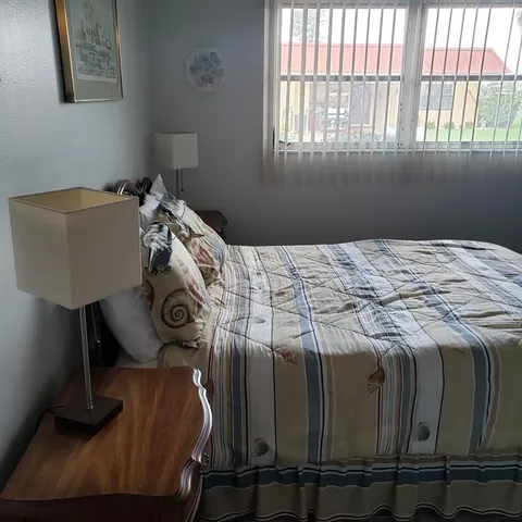 a bedroom with two beds and painting on the wall